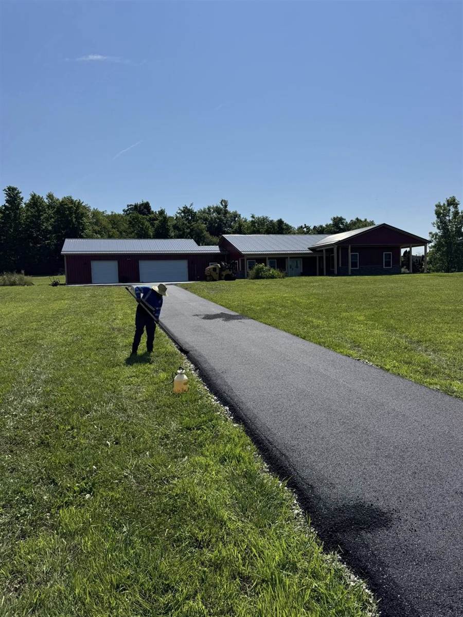 Long rural driveway leading to a country home