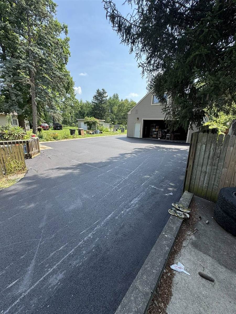 Wide residential drive with pole barn and garage access