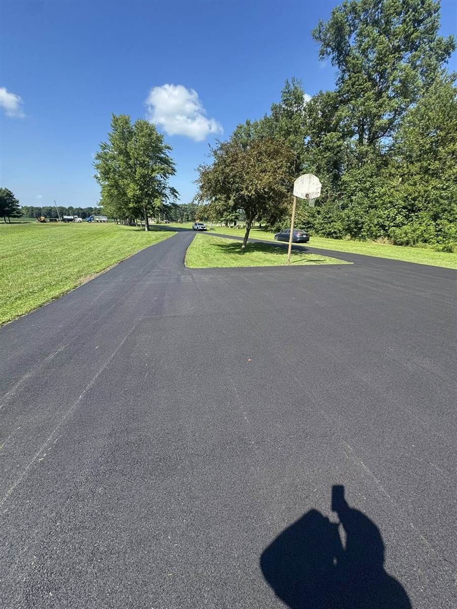 Private paved lane running through open Indiana countryside